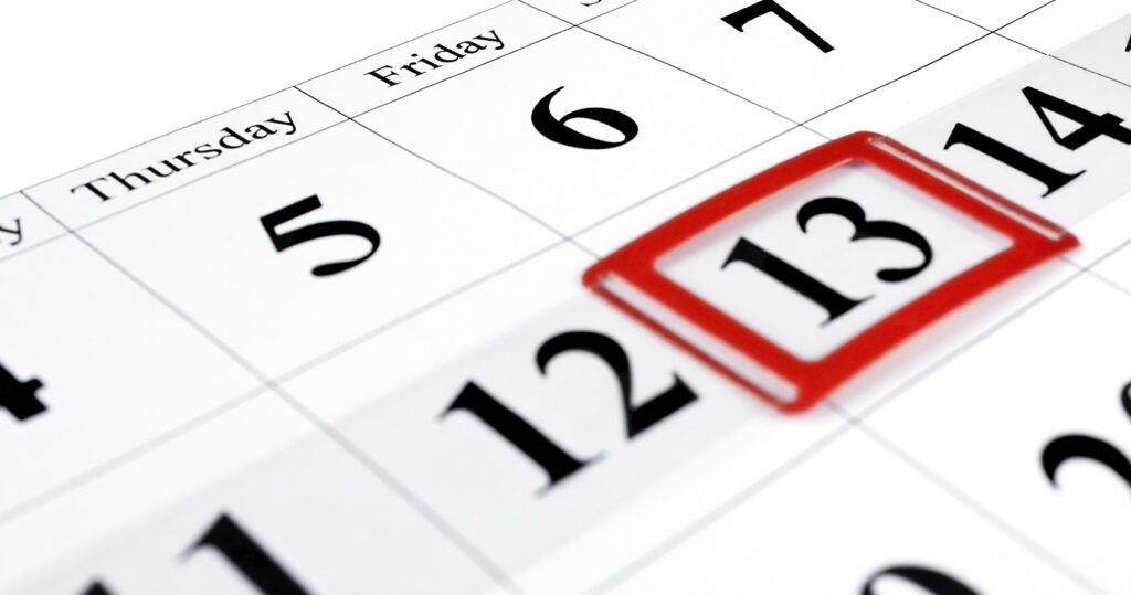 Close-up of a calendar with the number 13 outlined in red.