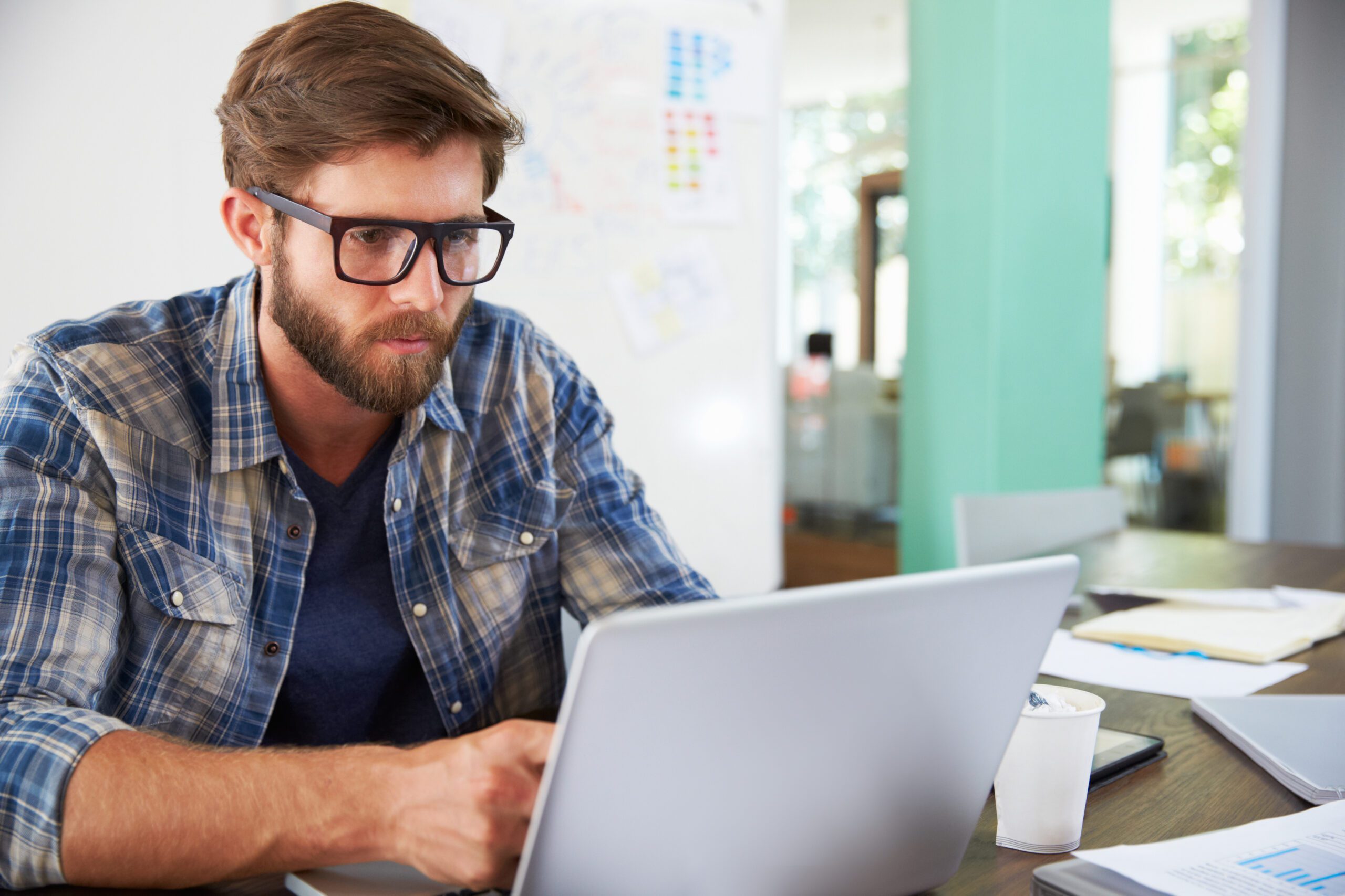 Professional attending virtual training session on computer at workplace.