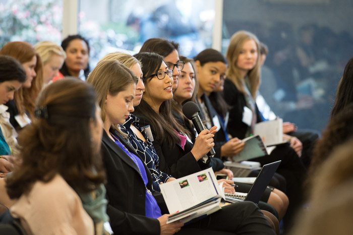 Audience member asking a question during a professional healthcare conference.