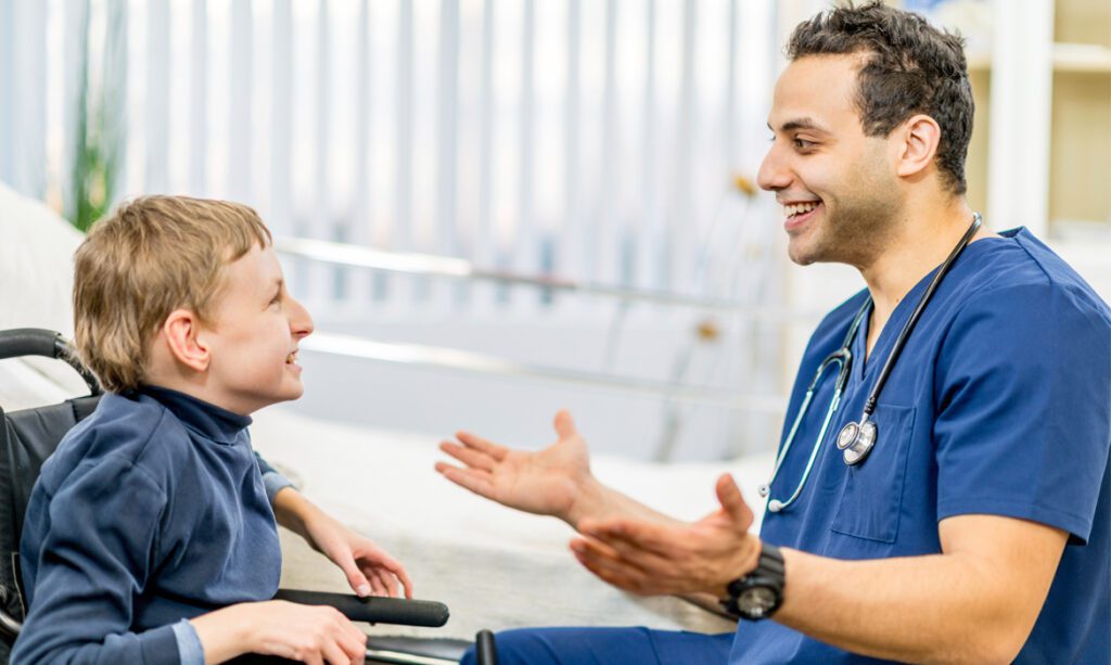 Medical professional engaging in a supportive conversation with a pediatric patient.