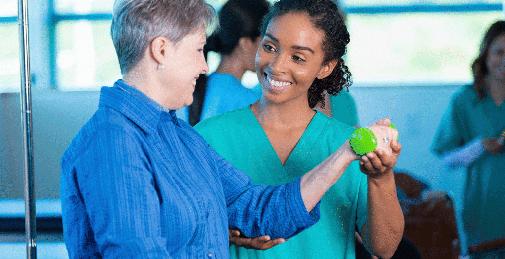 Healthcare professional supporting rehabilitation session, illustrating data-driven patient care