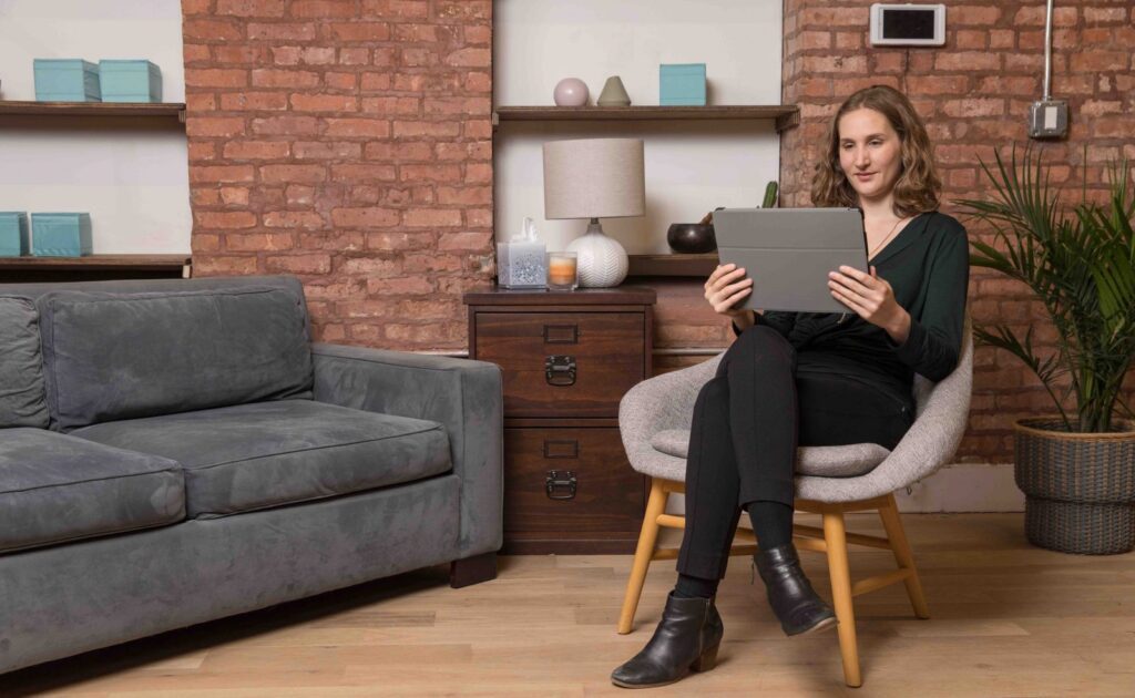 Patient participating in remote counseling through teletherapy platform.