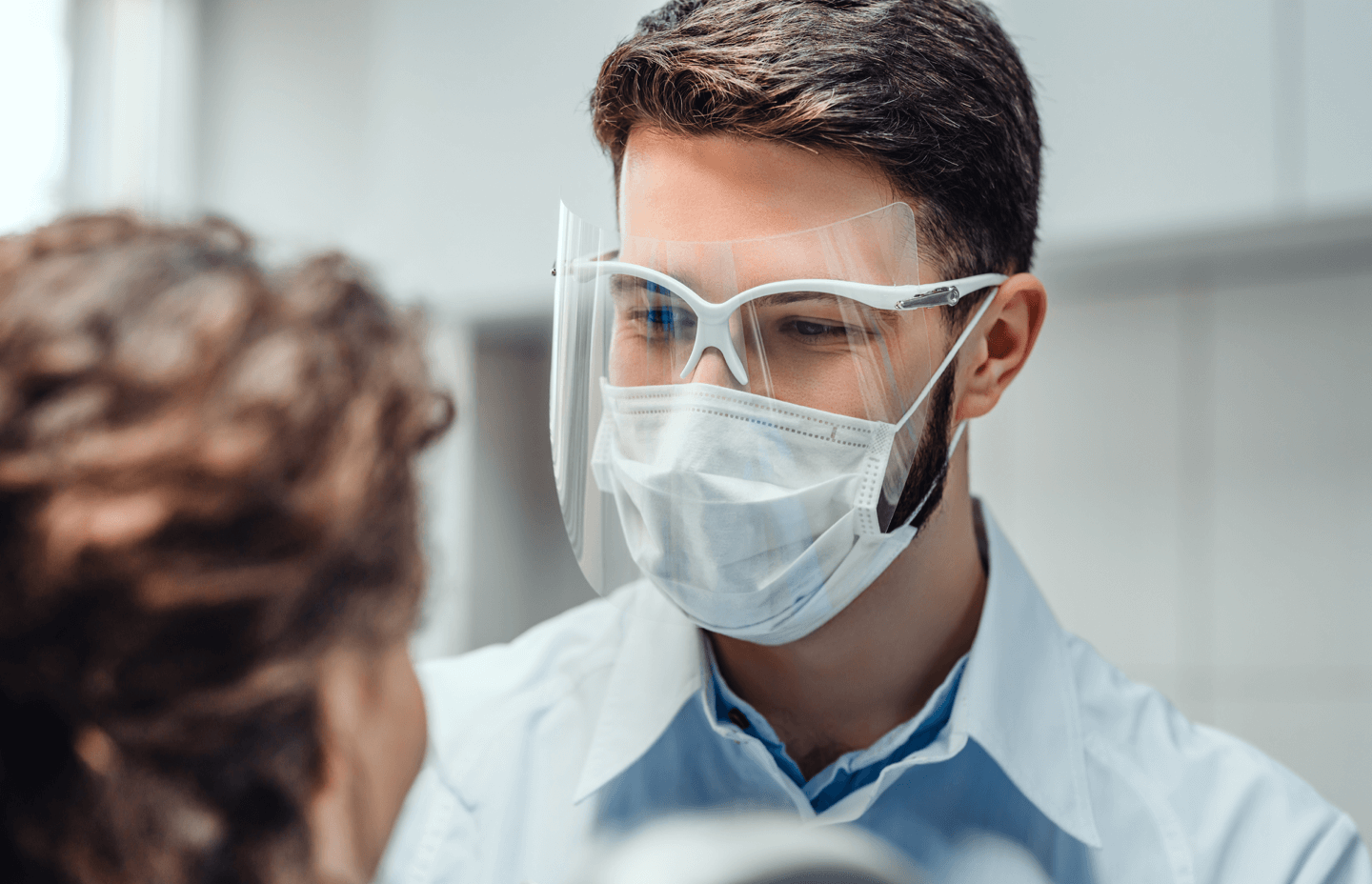 Doctor screening patient wearing face mask